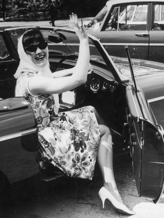 -a-Flower-Print-Dress-High-Heels-Headscarf-and-Sunglasses-Steps-out-of-a-Convertible-Car-Posters.jpg