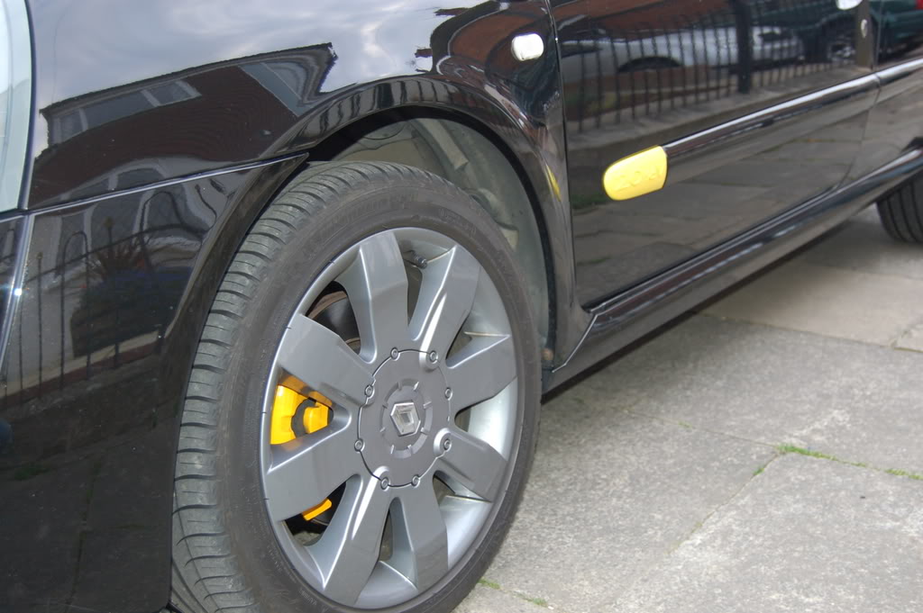 Yellow calipers on black car