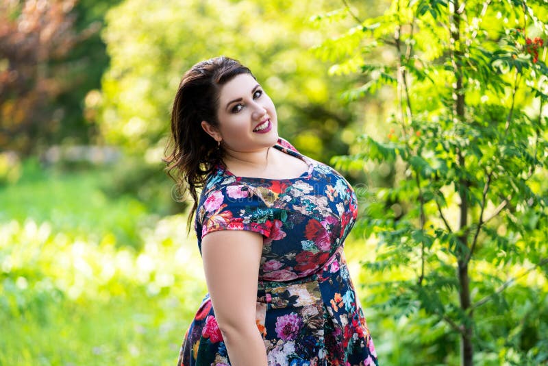 py-plus-size-model-floral-dress-outdoors-212657279.jpg