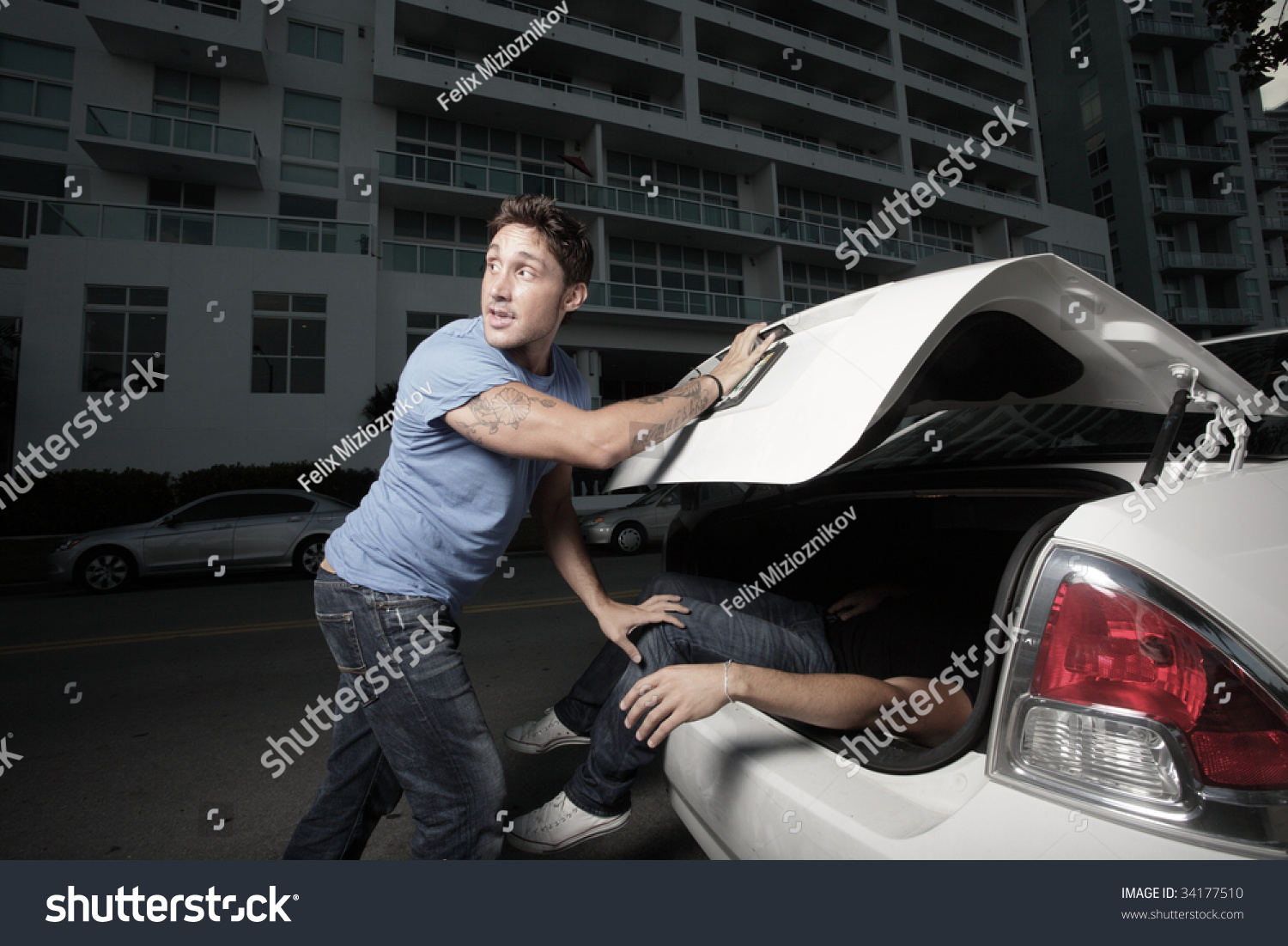 stock-photo-man-stuffing-a-dead-body-in-the-trunk-34177510.jpg