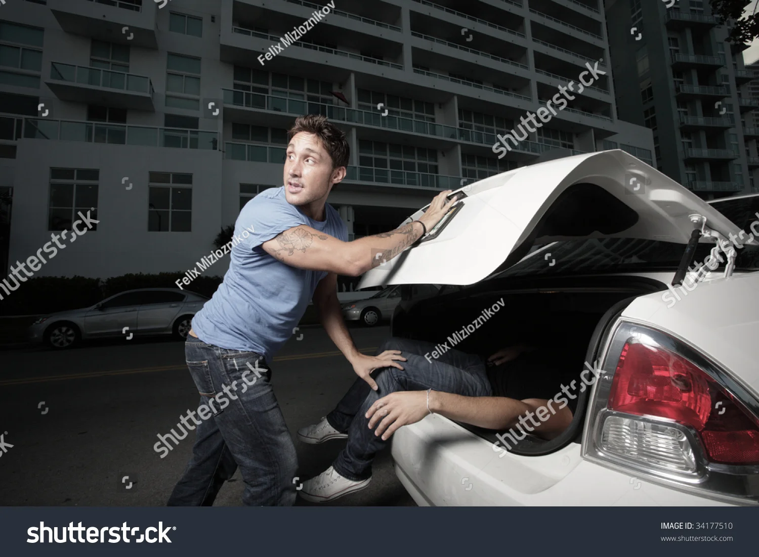 stock-photo-man-stuffing-a-dead-body-in-the-trunk-34177510.webp