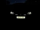 Front of car with angel and dlrl's on in dark.webp